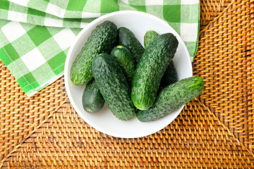 Fresh cucumbers with green checked cotton serviette on the table