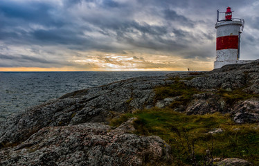 High ground lighthouse at the coast of Baltic Sea in Sweden in Sunset