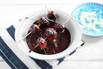 Served table with delicious strawberries in chocolate