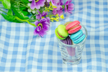 colorful macaroons on checkered tablecloth