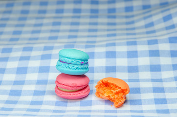 colorful macaroons on checkered tablecloth