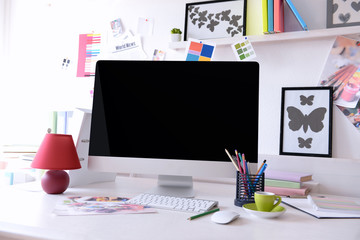 Modern computer on the table in decorated room