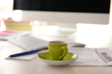 Green cup of coffee on modern table