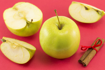Fresh apples and cinnamon sticks with a ribbon