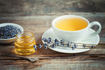Tea cup, jar of honey, dry lavender flowers and on background. R