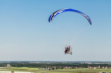 aerial view of paramotor flying over the fields