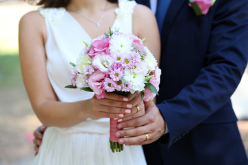 Bride and groom holding wedding bouquet