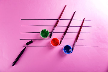 Creative music notes made of colourful paints on pink background