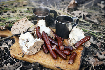 Grilled sausages on cutting board in the wood
