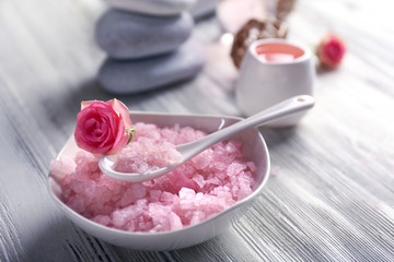 Composition of flowers, salt and stones on white wooden background, in spa salon