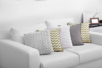 Sofa with colorful pillows in room