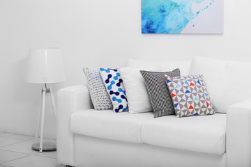 Sofa with colorful pillows in room