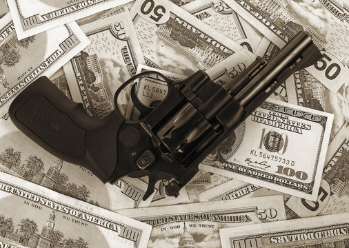 black revolver on money hundred dollar bill. black and white