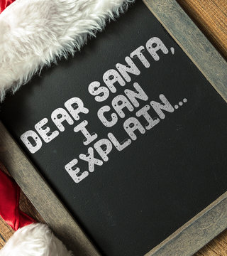 Blackboard with the text: Dear Santa, I Can Explain...