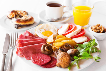 Traditional english breakfast with egg, bacon, mushrooms and tea