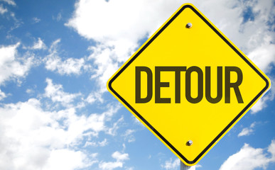 Detour sign with sky background