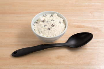 Chocolate chip cookie mix in bowl plus spoon