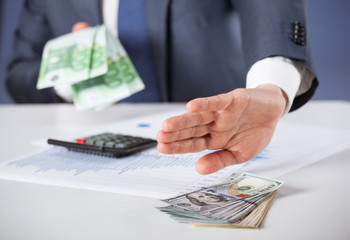 Businessman refusing dollars and choosing euro