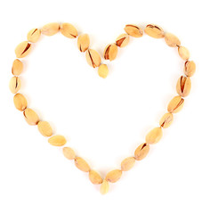 Heart shaped peanuts isolated on white