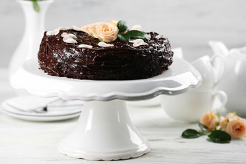 Chocolate cake decorated with flowers on the table