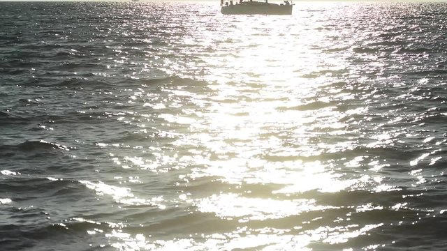 Sailing boat stopped on the sea, reflections at dusk
