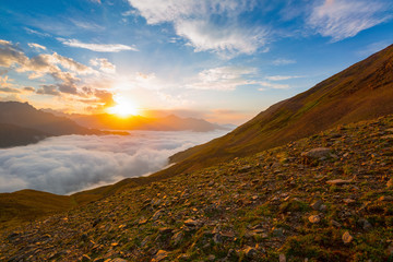 Fototapeta na wymiar Sunset over cloudy walley at Caucasus mountains