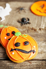 Creative cookies for Halloween party on wooden table, close up