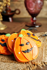 Creative cookies for Halloween party on wooden table, close up
