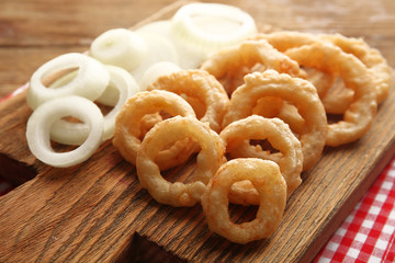 Chips rings with onion on cutting board closeup