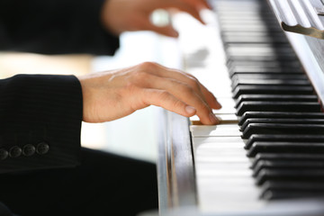 Obraz premium Close up of man hands piano playing