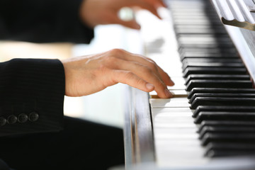 Close up of man hands piano playing