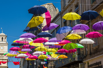 Street decorated with colored umbrellas. Arles, Provence. France