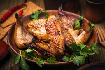 Baked chicken wings in the oven, close-up