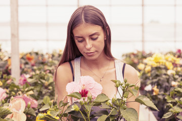 young flower seller takes care of her beautiful flowers