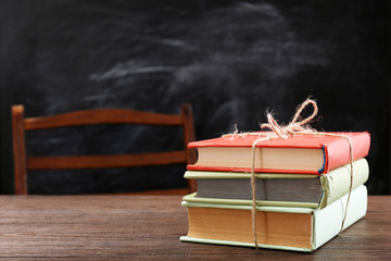 Colourful pile of books on wooden table