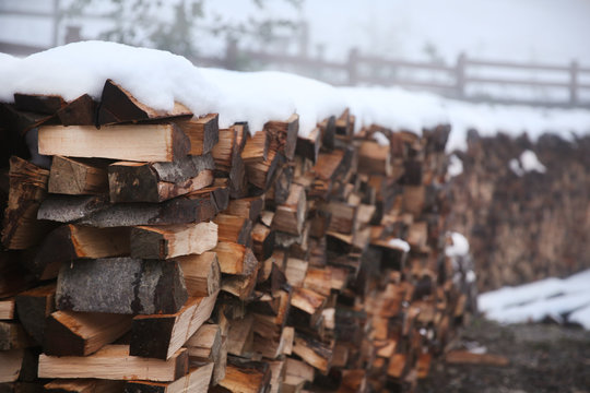 Logs of fire wood under snow