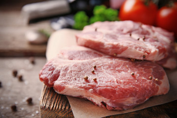 Marbled beef steak and spices on wooden background