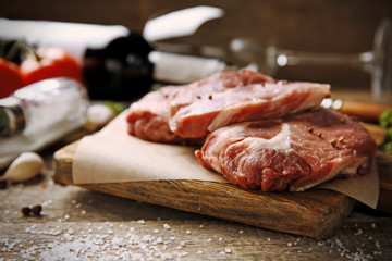 Marbled beef steak and spices on wooden background