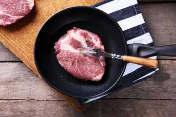 Marbled beef steak and spices on wooden background