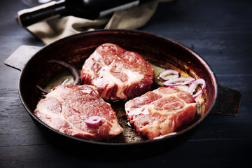 Marbled beef steak and wine bottle on wooden background
