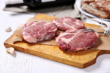 Marbled beef steak with bottle of wine and spices on wooden background