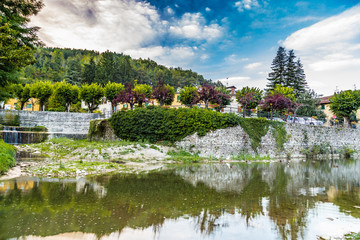 river through mountain village in Tuscany