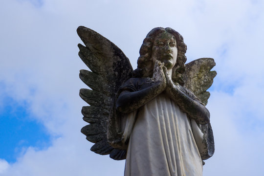 Praying Angel Statue under Blue Sky