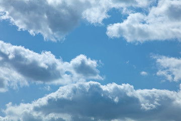 Fototapeta na wymiar White clouds running over blue sky