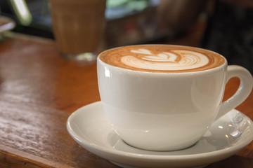 Close up white cup of Coffee, latte on the wooden table