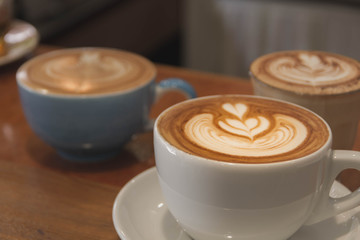 Close up white cup of Coffee, latte on the wooden table