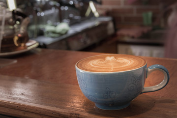 Close up blue cup of Coffee, latte on the wooden table