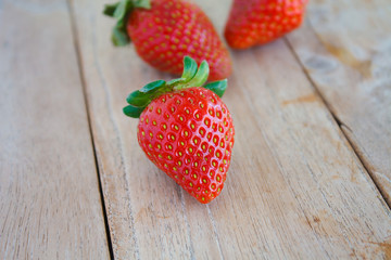 Fresh red strawberries on wooden table