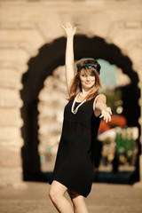 Fototapeta premium Flapper girl woman in1920s style standing on the street