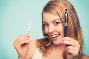 Obraz premium Girl with normal and electronic cigarette.